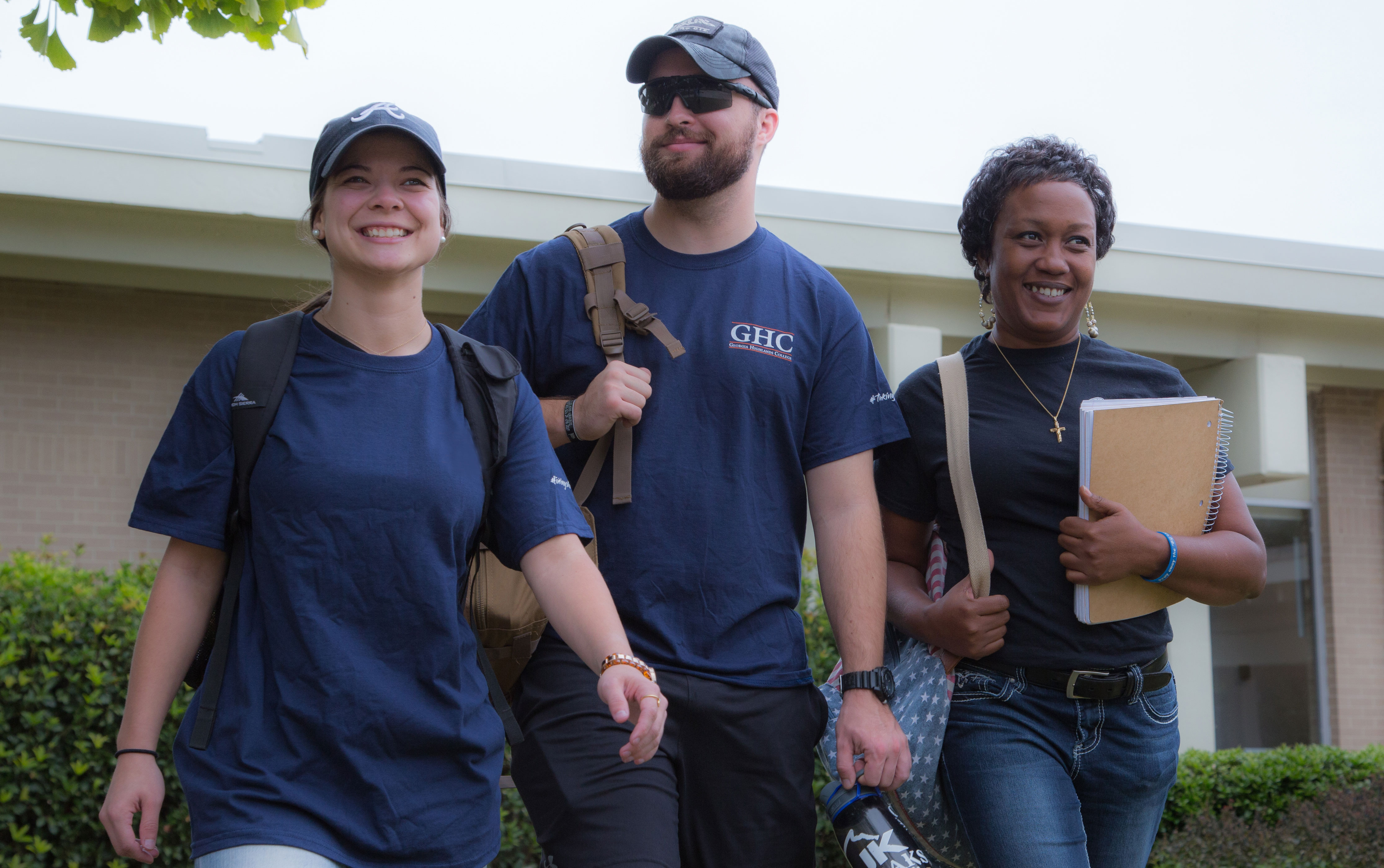 three students walking on campus